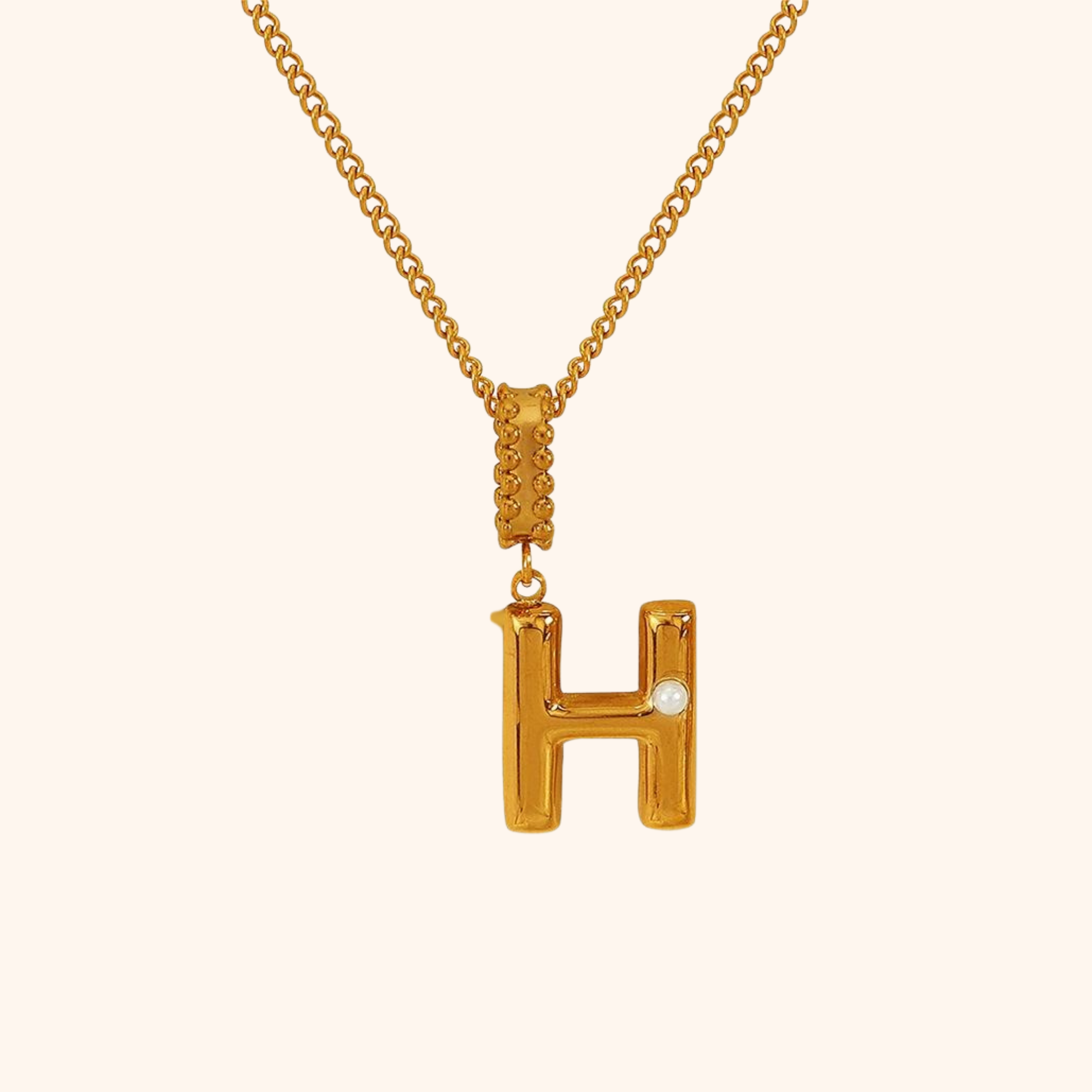 H letter necklace in gold with freshwater pearl accent